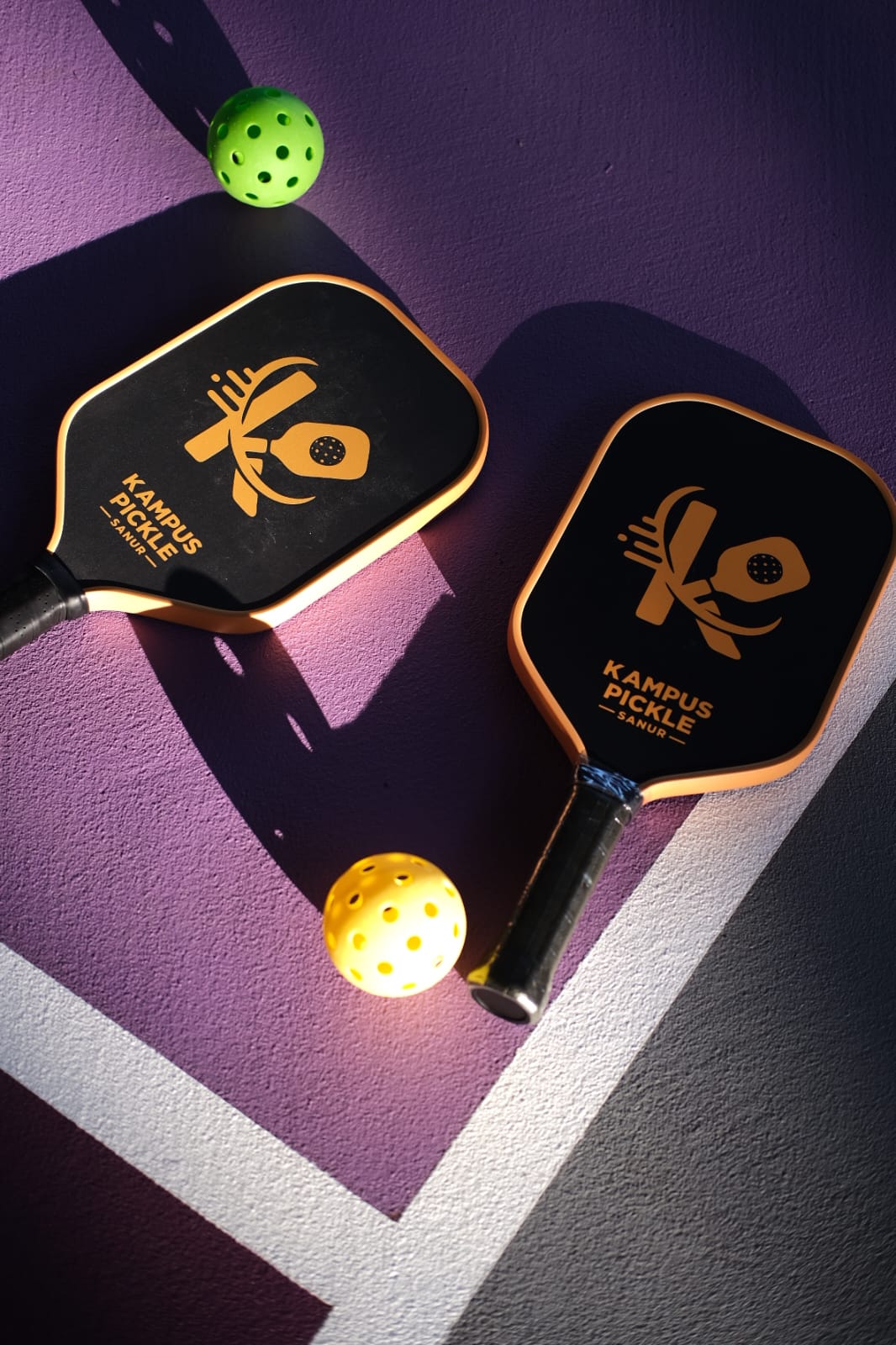 Freshly painted purple pickleball courts under evening lights
